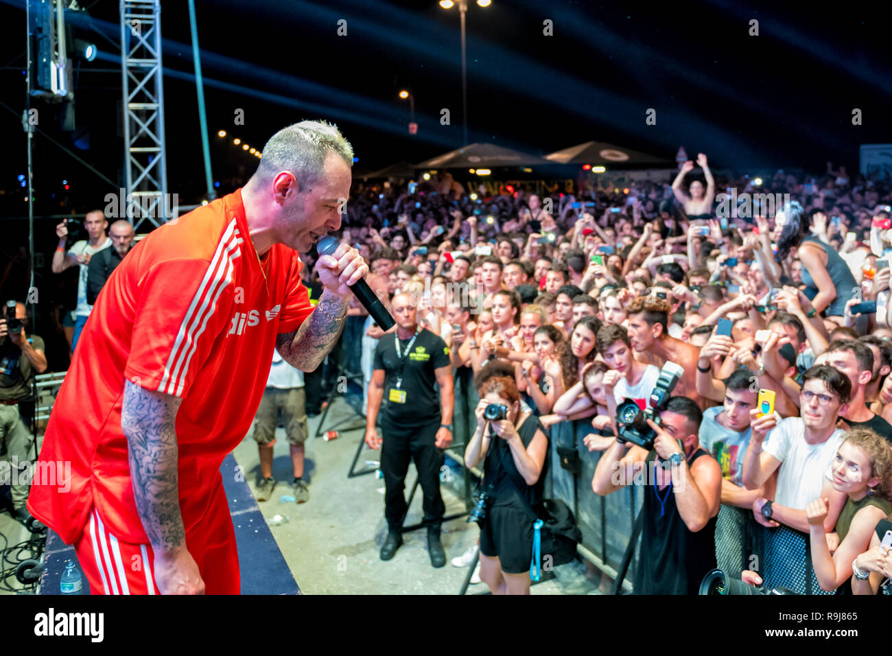 RIMINI, ITALIA - JUNE 24, 2017: Molo Street Parade Rimini, the Italian singer Fabri Fibra performs live singing his greatest hits. Stock Photo