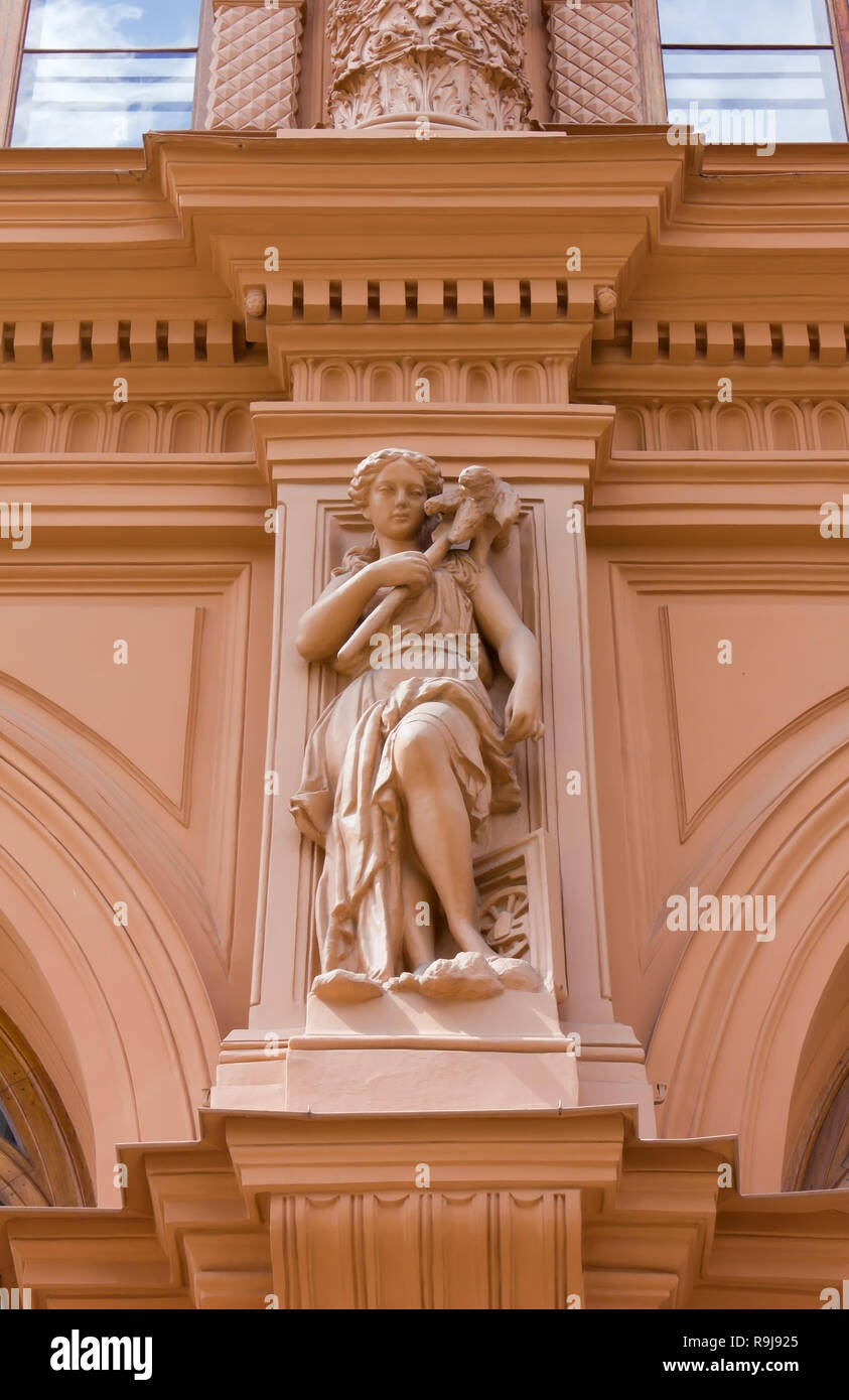 RIGA, Latvia - July 18, 2013: Close-up on a Historic Building's Facade with Feminine Statue Stock Photo