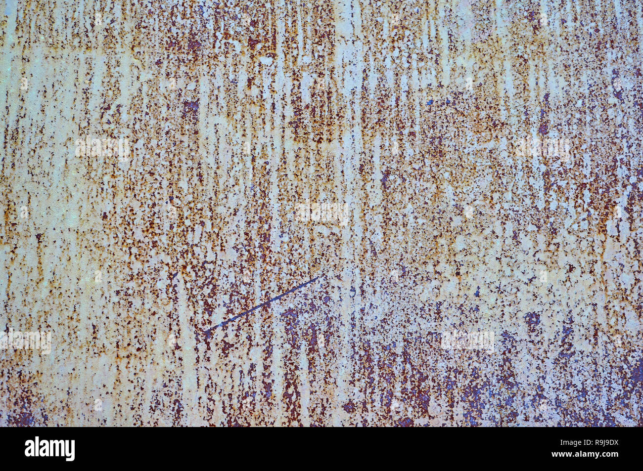 Old metal shield is painted gray paint with rust and cracks. Stock Photo