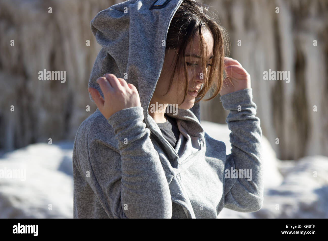 Girl in the hood. beautiful pensive girl puts on a hood. in the hood Stock Photo Alamy