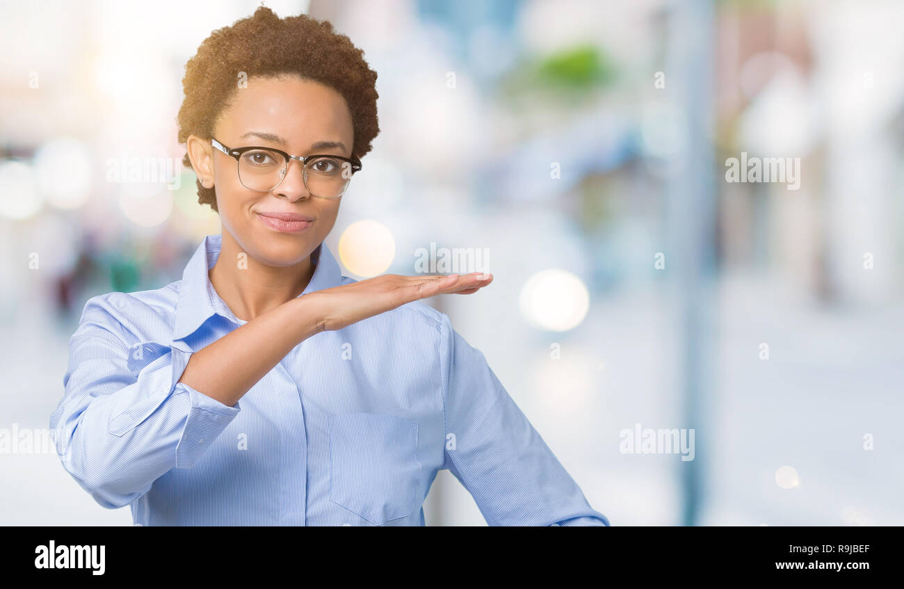 Young beautiful african american business woman over isolated ...