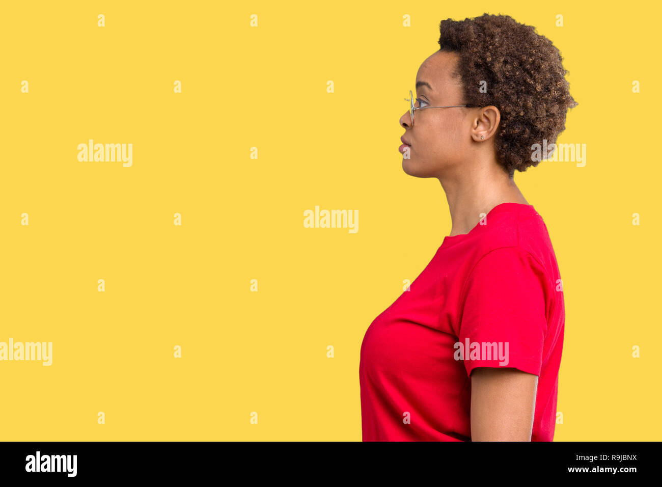 Beautiful young african american woman wearing glasses over isolated ...