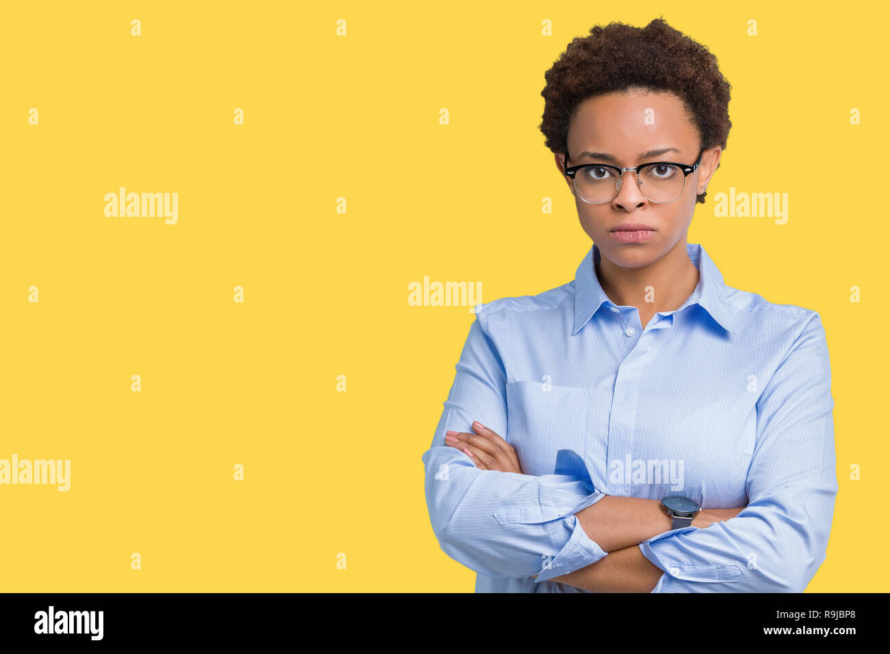 Young beautiful african american business woman over isolated background skeptic and nervous, disapproving expression on face with crossed arms. Negat Stock Photo