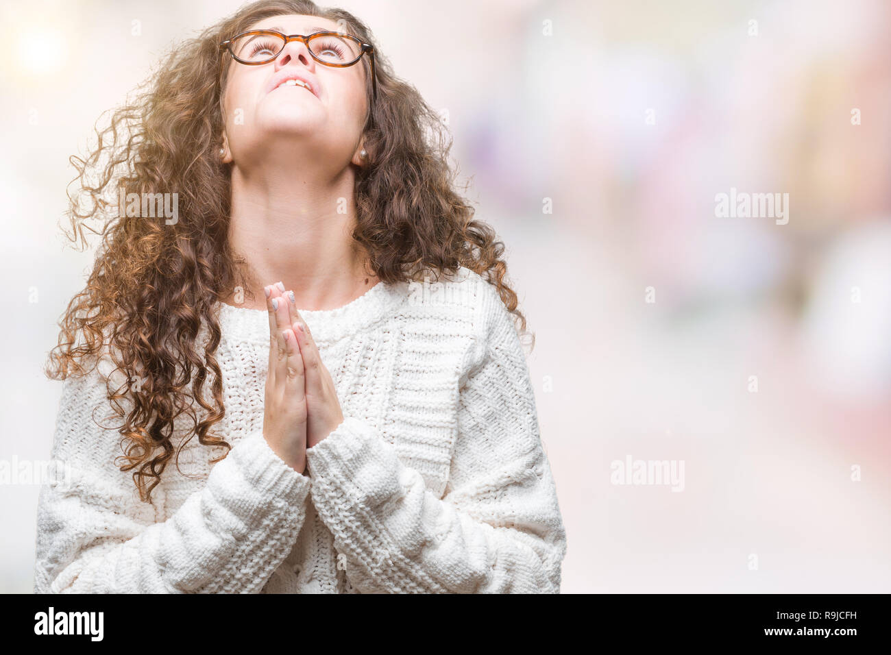 Beautiful brunette curly hair young girl wearing winter sweater over ...