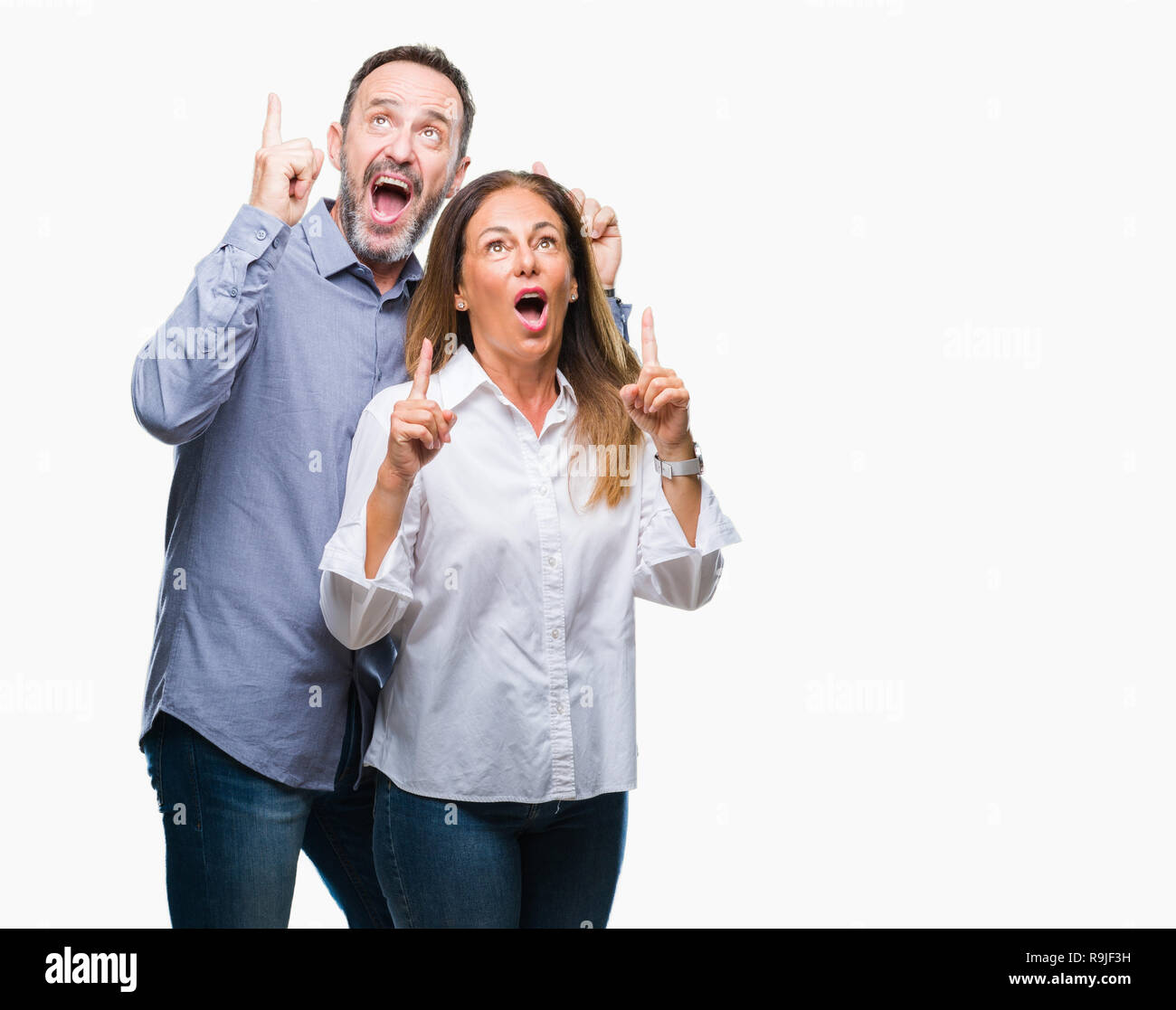Middle age hispanic business couple over isolated background amazed and ...