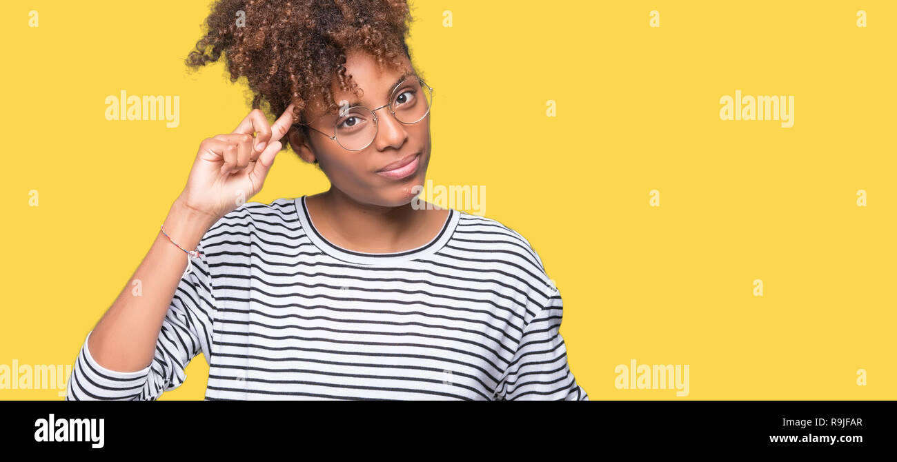 Beautiful young african american woman wearing glasses over isolated background Smiling pointing to head with one finger, great idea or thought, good  Stock Photo