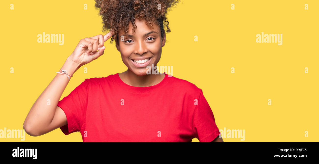 Beautiful young african american woman over isolated background Smiling pointing to head with one finger, great idea or thought, good memory Stock Photo