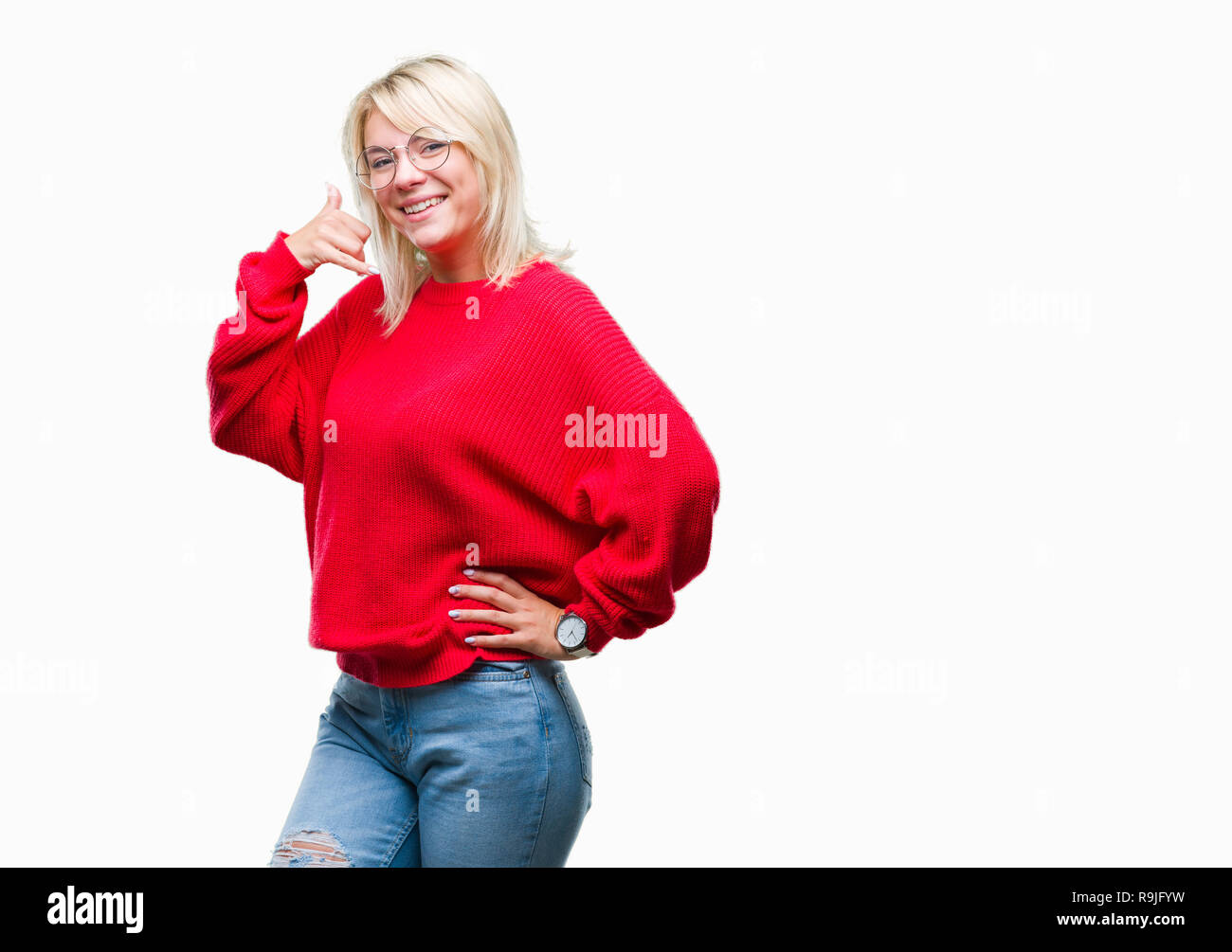 Young beautiful blonde woman wearing sweater and glasses over isolated background smiling doing phone gesture with hand and fingers like talking on th Stock Photo