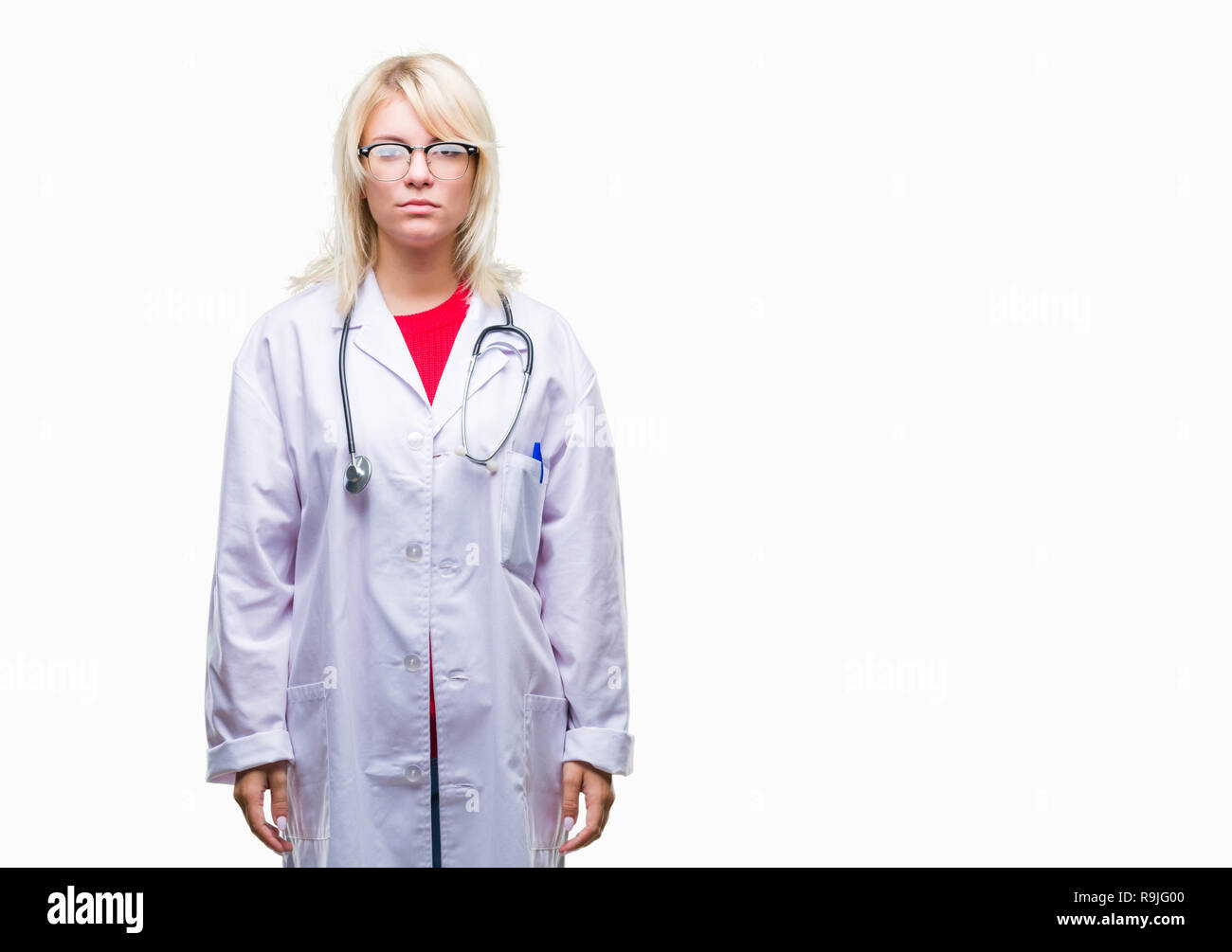 Young beautiful blonde doctor woman wearing medical uniform over isolated background with serious expression on face. Simple and natural looking at th Stock Photo