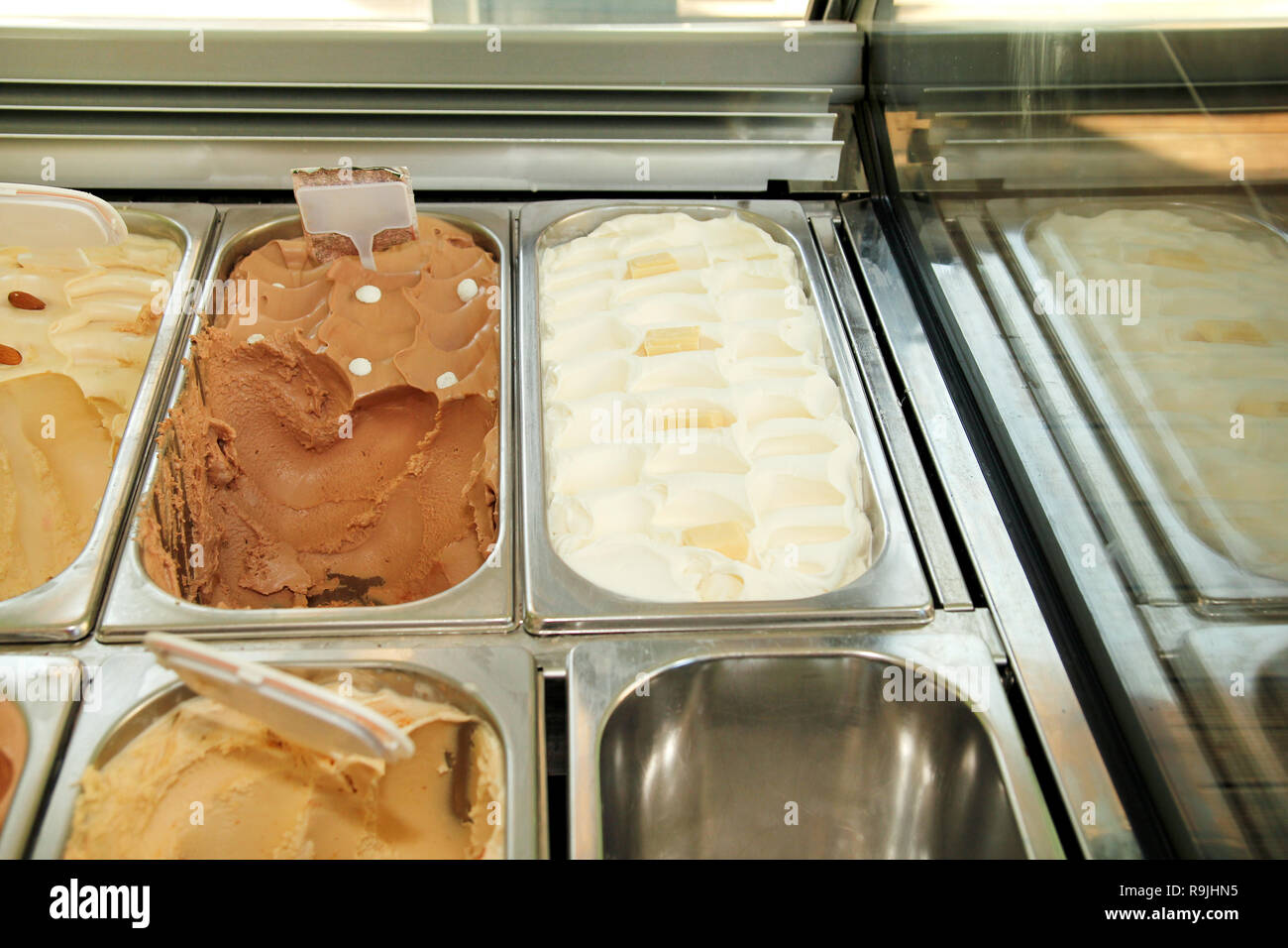 Bar with many flavors of delicious ice cream for sale. Fridge with