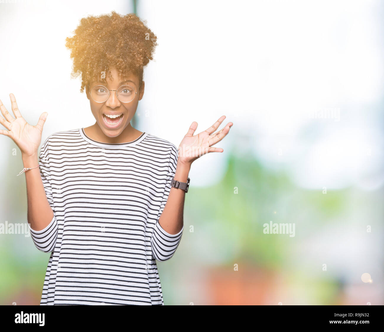 Beautiful young african american woman wearing glasses over isolated ...
