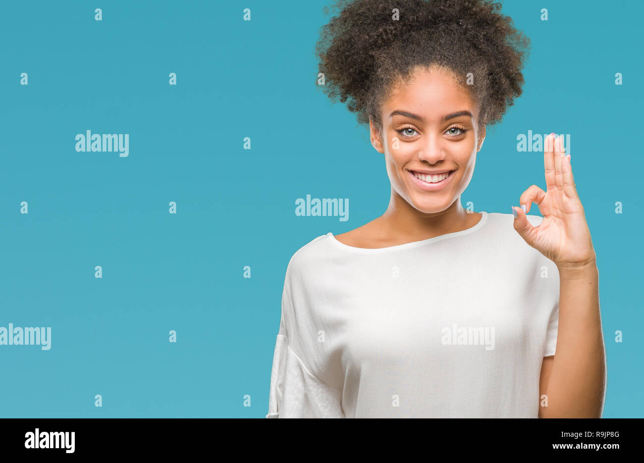 Young afro american woman over isolated background smiling positive ...