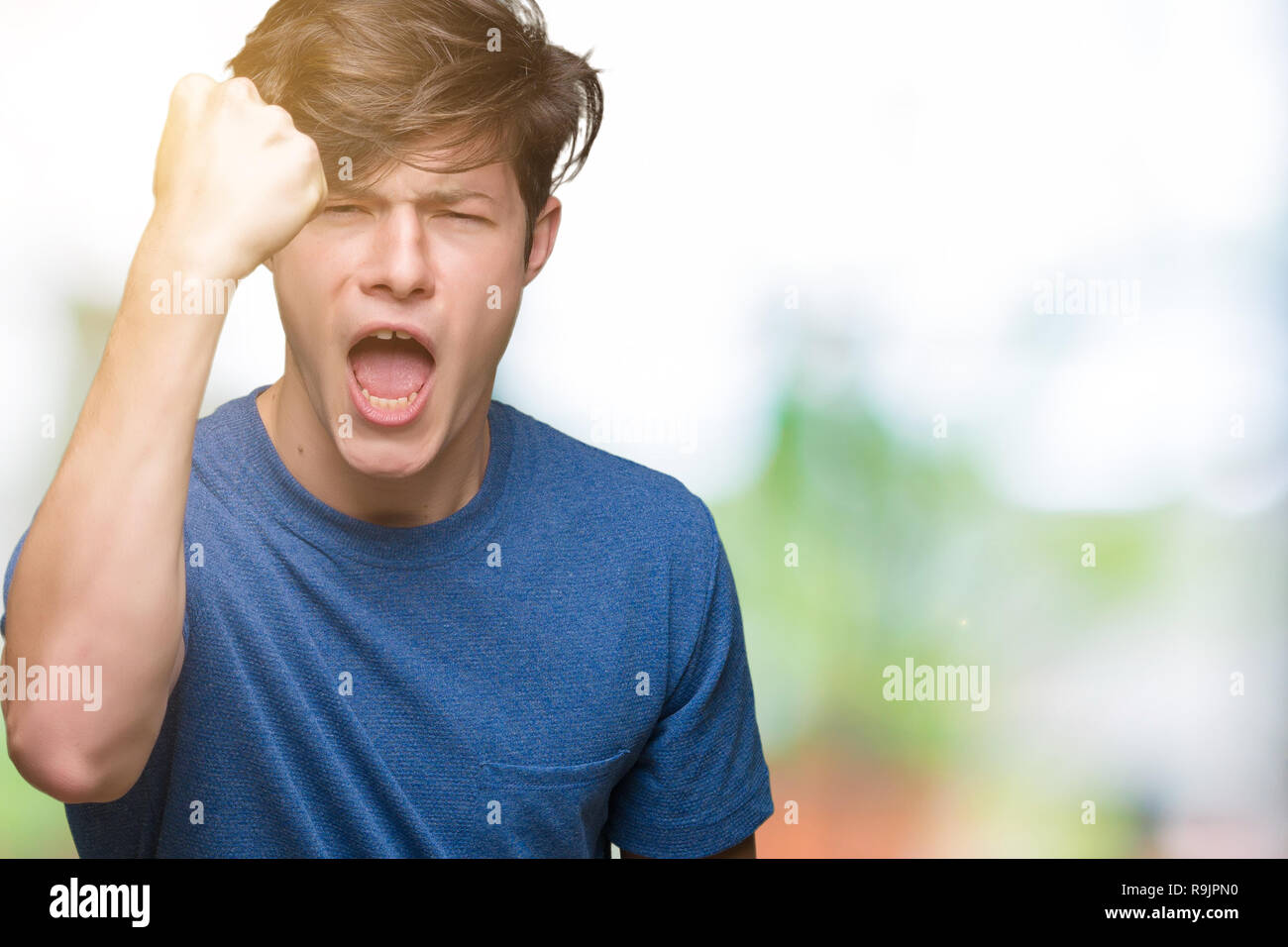 Young handsome man wearing blue t-shirt over isolated background angry ...