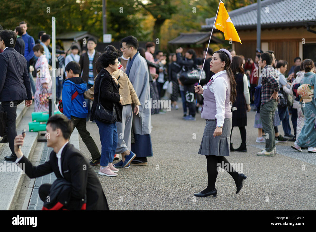 Kyoto, Japan. A tour guide leads a tourist group visiting Stock Photo