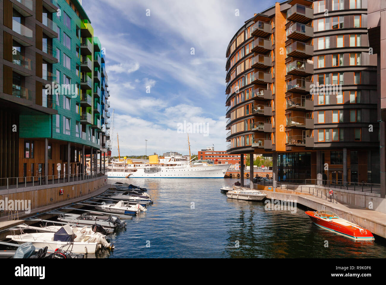 OSLO, NORWAY - JULY 23, 2018: Modern scandinavian architecture at renovated Tjuvholmen waterfront district. HNoMY Norge Royal Yacht of the King of Nor Stock Photo
