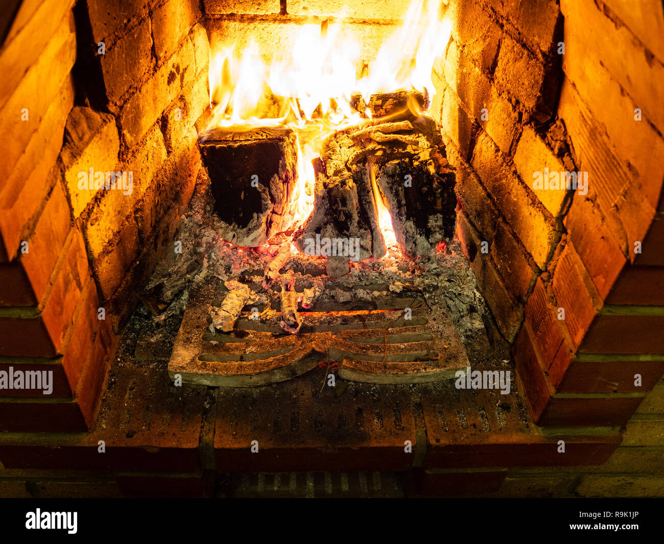 grate and burning firewood in fireplace in rural house Stock Photo Alamy