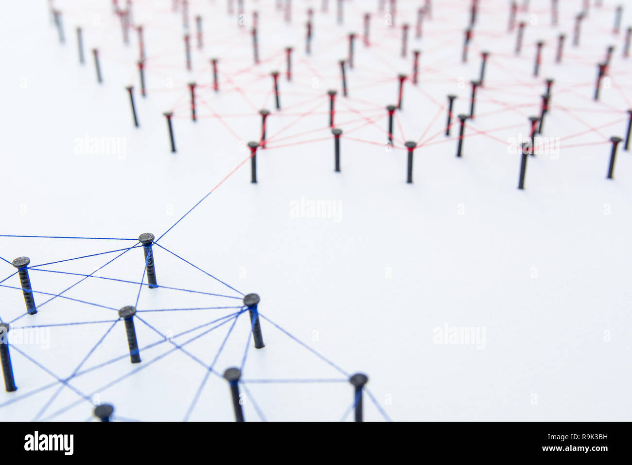 Connecting networks concept two network connected with yarn red and