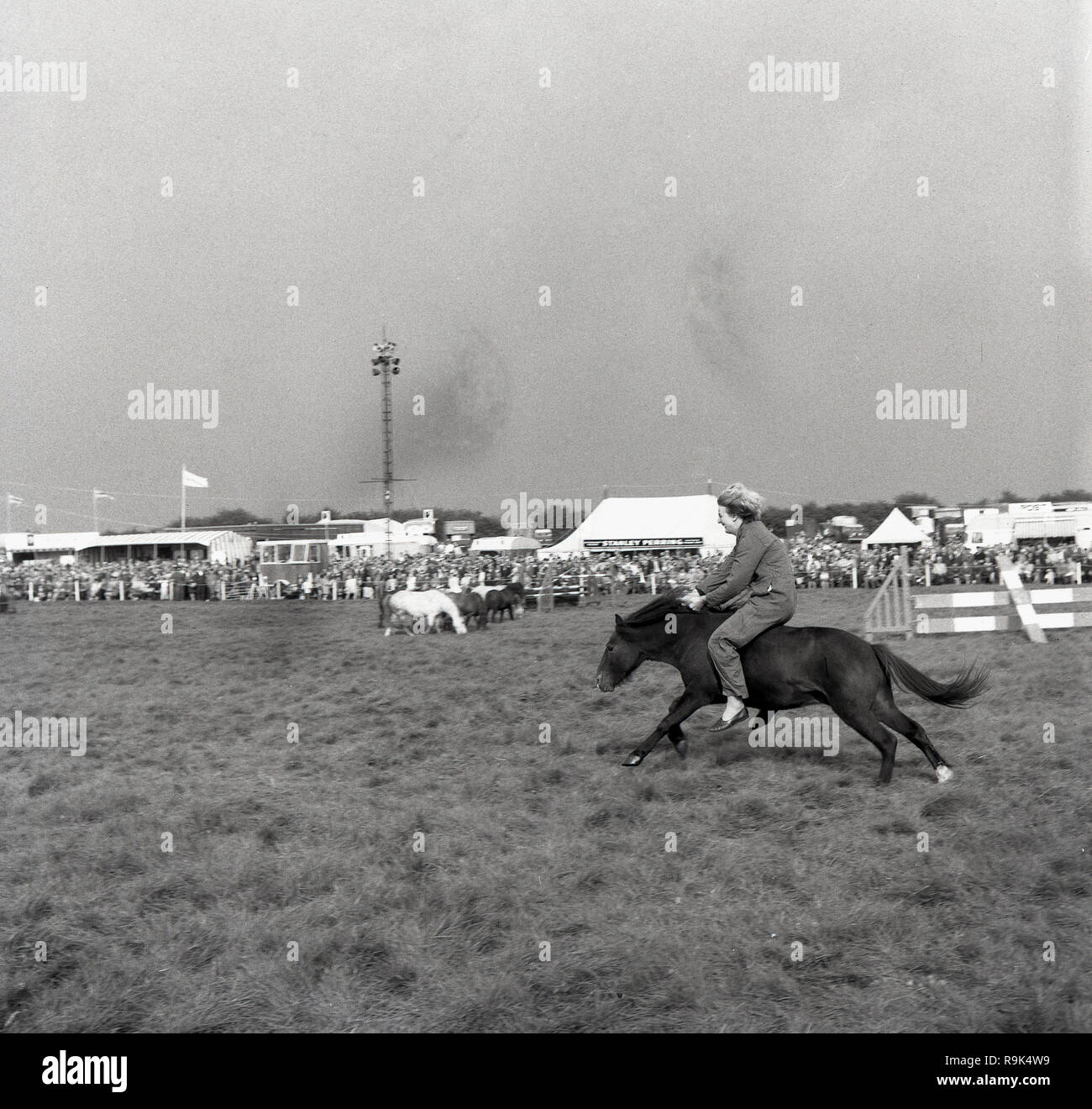 1967, Thame Show, Oxfordshire, a lady riding a small horse bareback, without a saddle or harness, holding on to the horse's mane, England, UK. The show is the largest one-day agricultural show in Britain and the although the first official event was held in 1888, it's origins date back to 1855 when a ploughing competition was held there. Stock Photo
