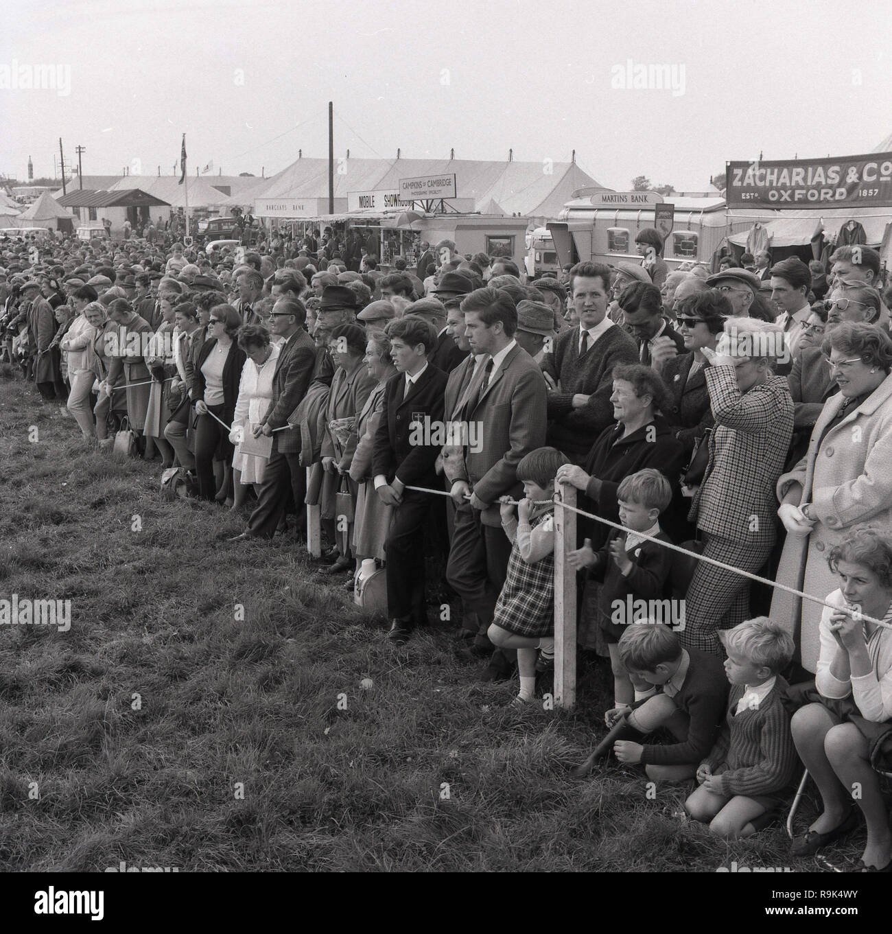 1967, visitors to the Thame Show, Oxfordshire, the largest one-day agricultural show in Britain, standing in a field watching the proceedings, England, UK. Stock Photo