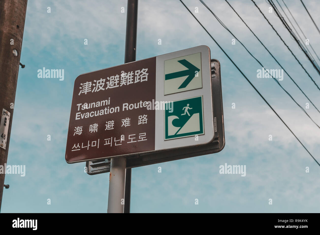 Tsunami warning sign on the shore of Uchiura Bay to tell the escape route in case of huge wave strike the shore as a result of earthquake Stock Photo