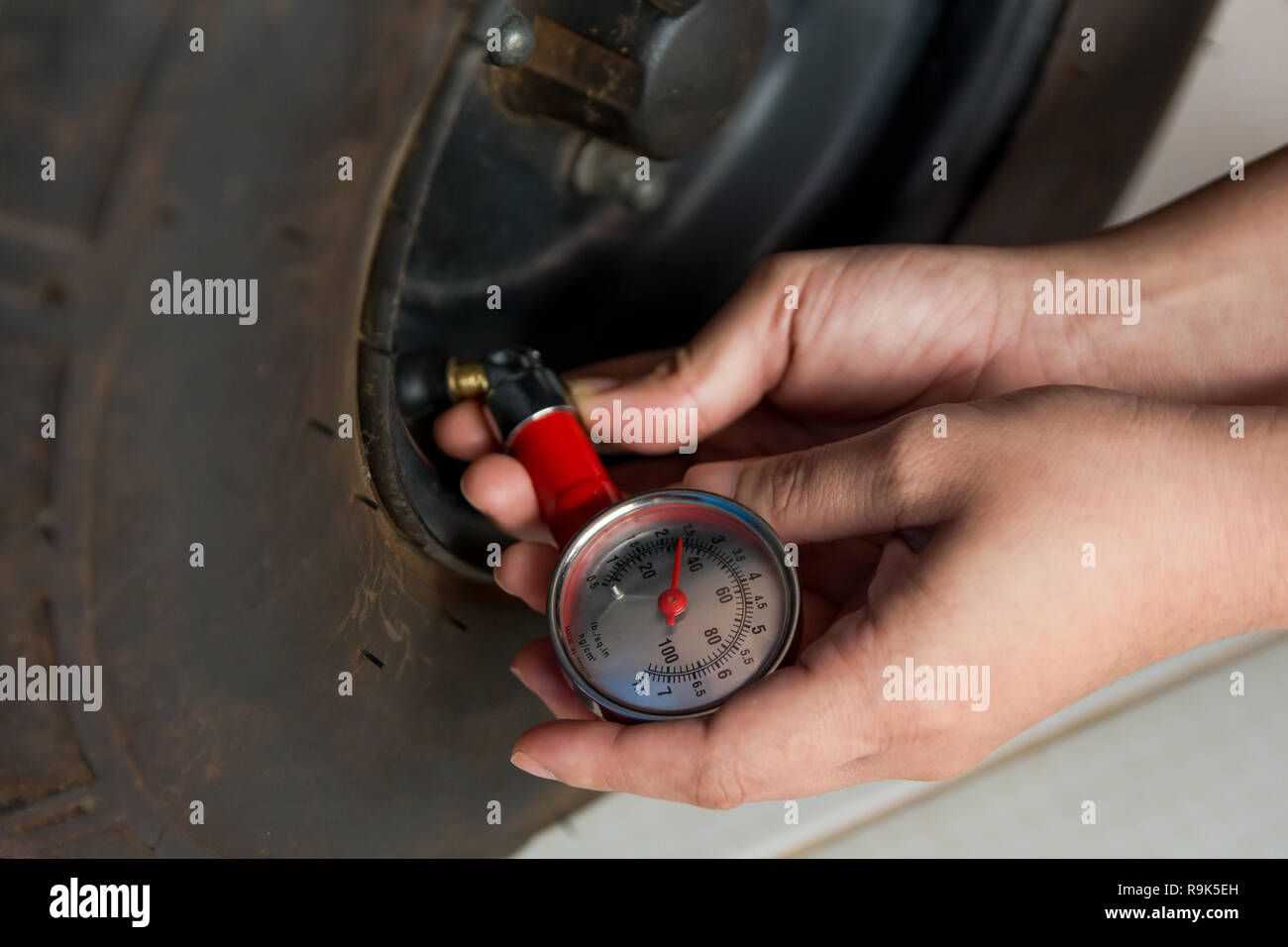 Tire pressure gauge : Hand holding pressure gauge checking air pressure ...
