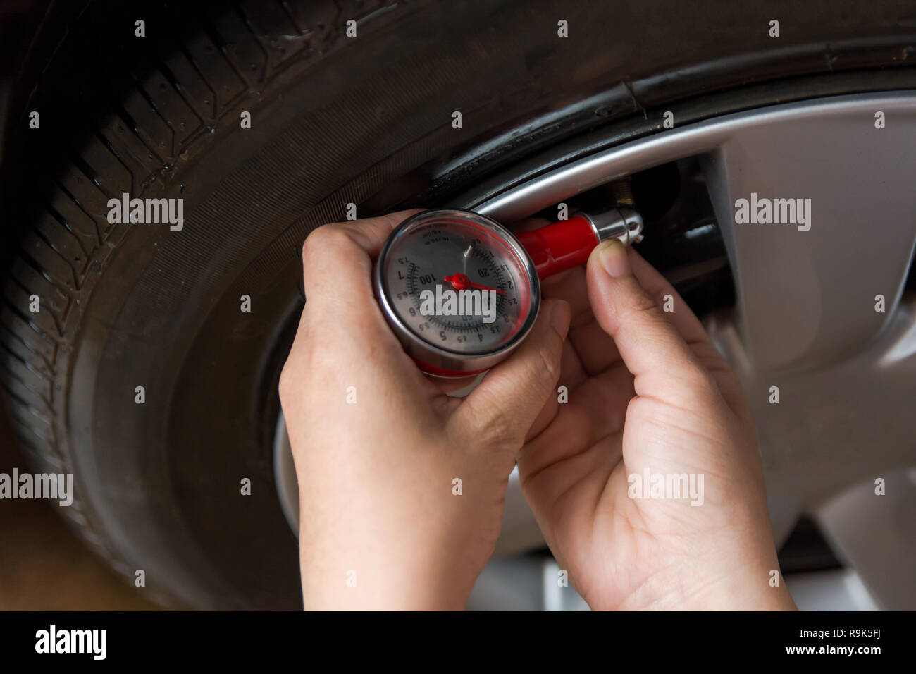 Tire pressure gauge : Hand holding pressure gauge checking air pressure ...