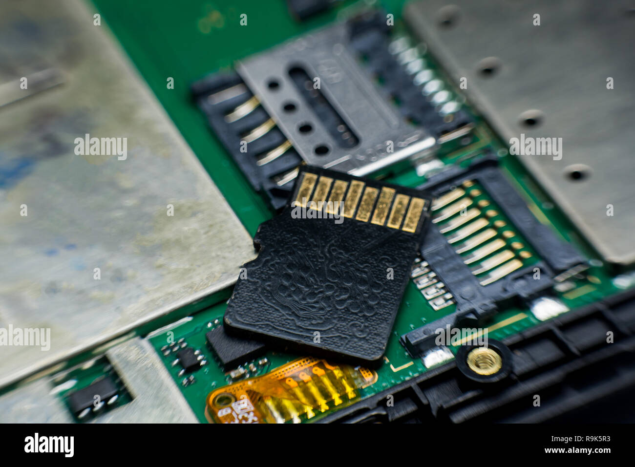 Micro sd card slot inside electronic circuit board smart phone. disassembled cell phone parts. Stock Photo