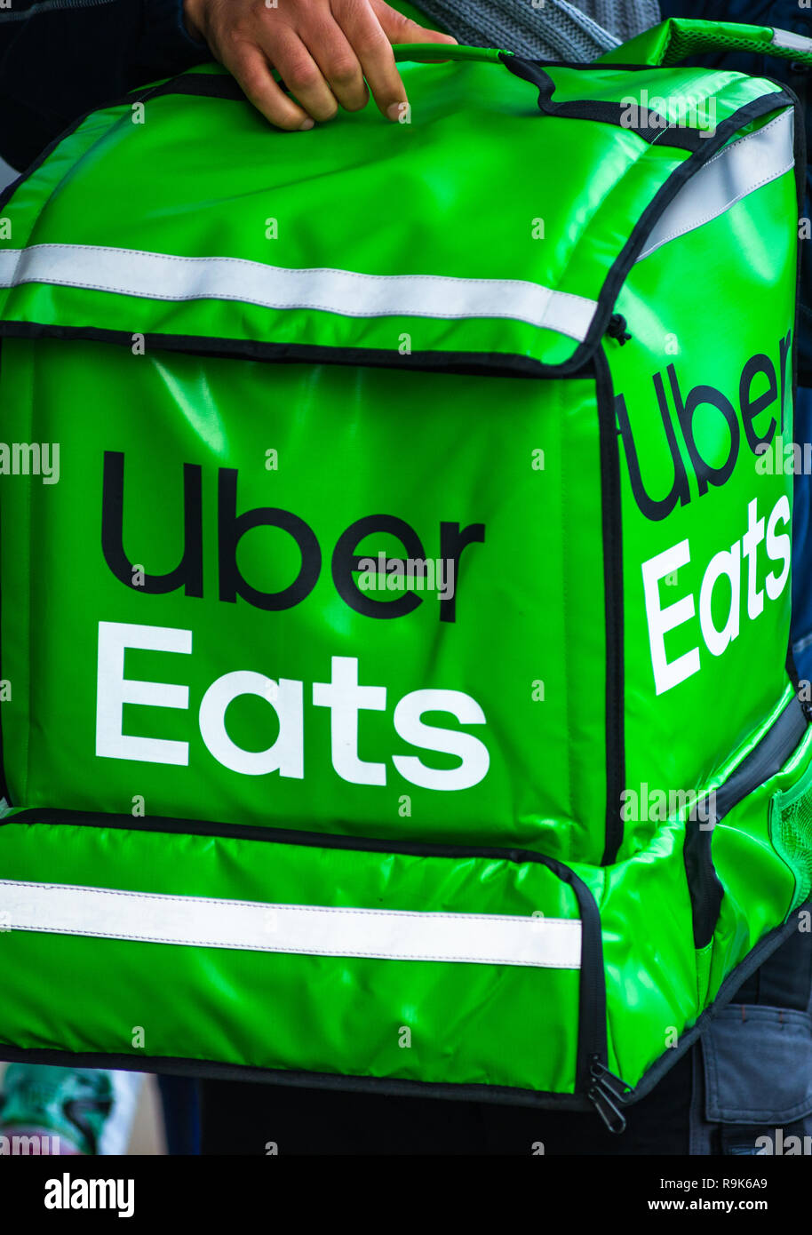 Uber Eats is an American online food ordering and delivery service. Delivery in progress on Vienna street. Austria. Stock Photo