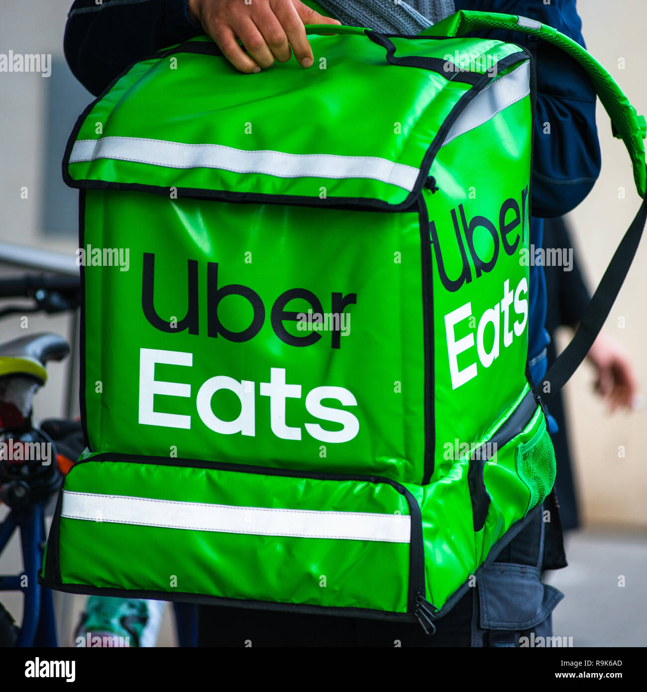 Uber Eats is an American online food ordering and delivery service. Delivery in progress on Vienna street. Austria. Stock Photo