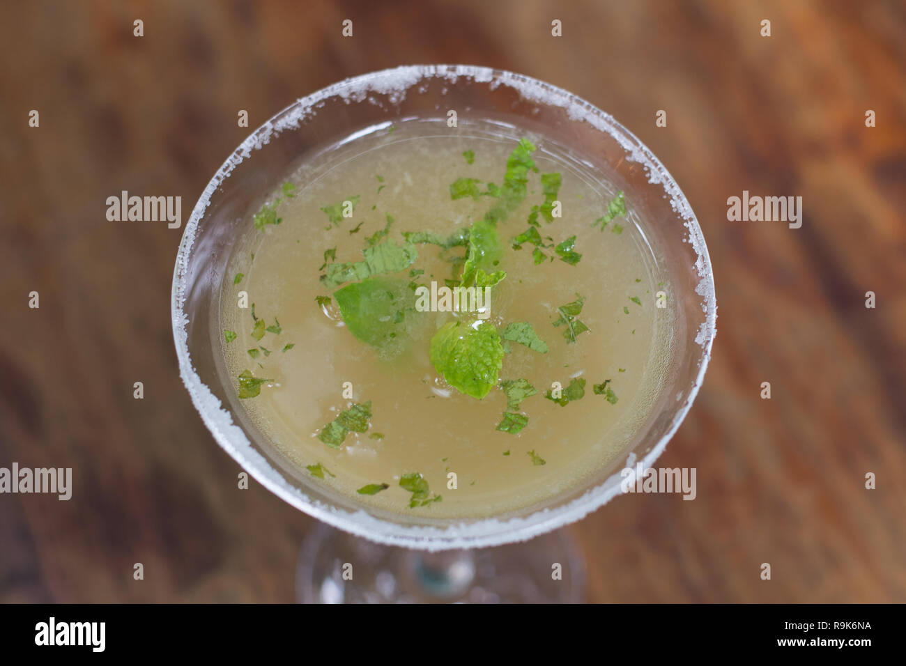 A cocktail of Tequila, lime, mint leaves, and passionfruit Stock Photo