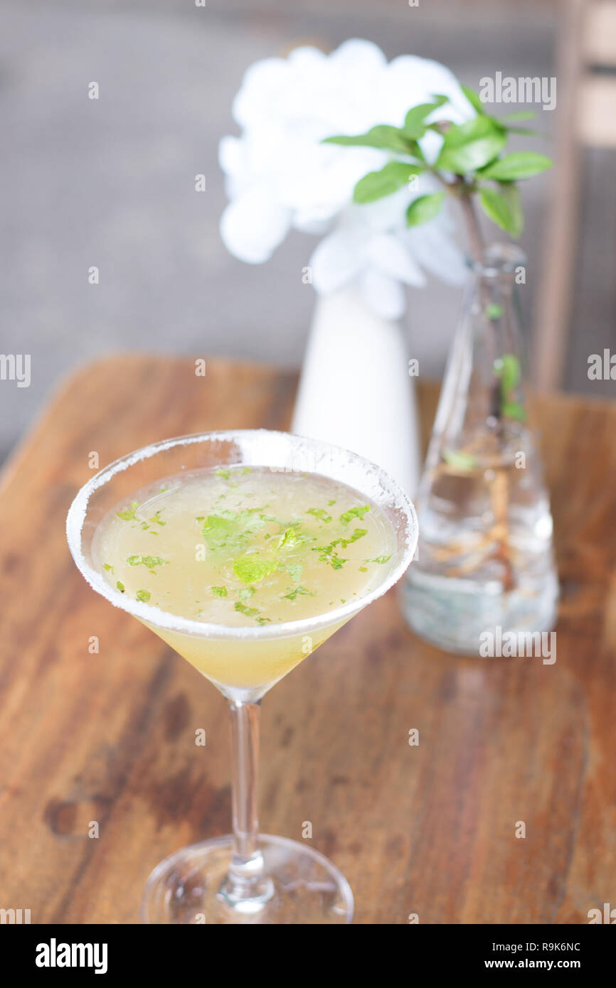A cocktail of Tequila, lime, mint leaves, and passionfruit Stock Photo