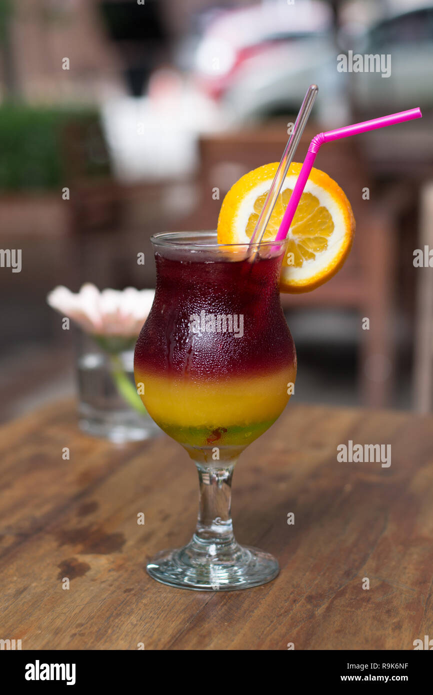 A colourful cocktail of banana liqueur, green Midori, orange juice and