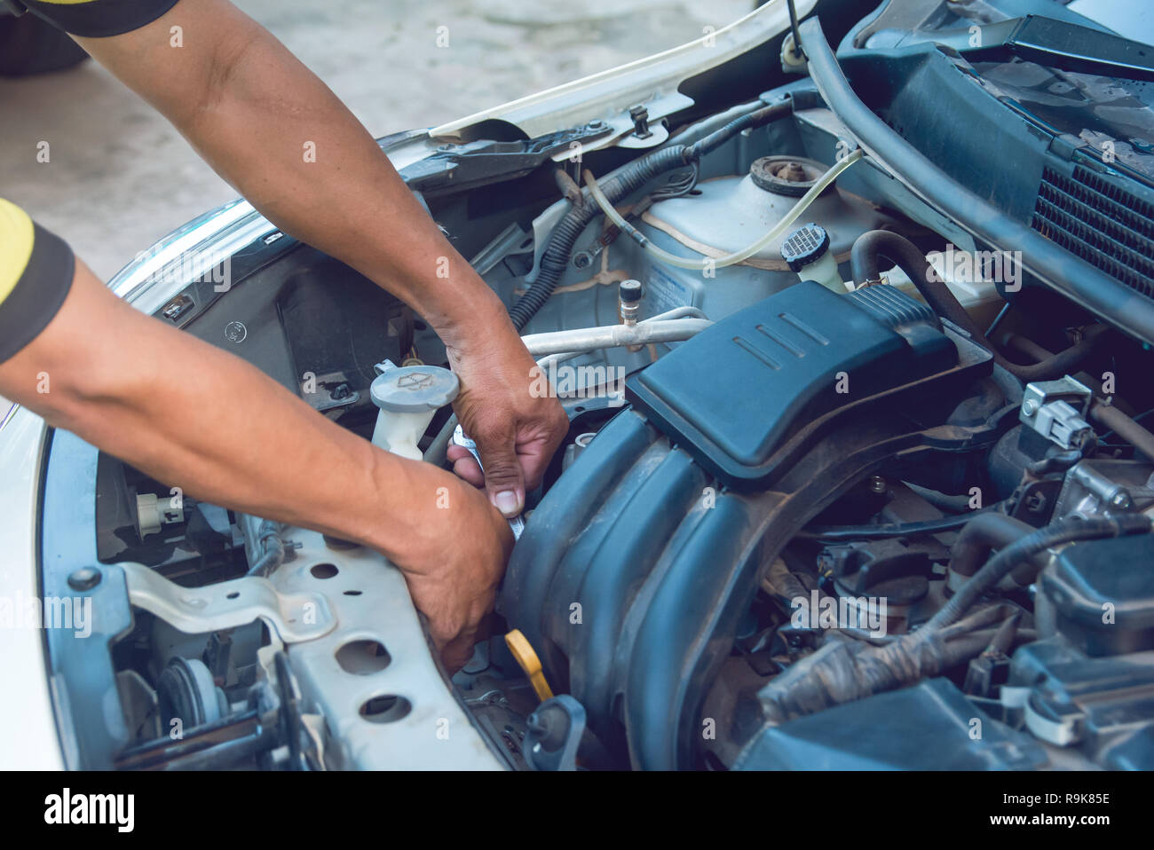 Car Mechanic Working With Wrench In Garage Repair Service Stock