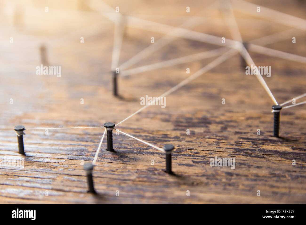Connecting networks concept - network connected with yarn white on Plank wood with copy space. Simulator connection social media, internet, people com Stock Photo