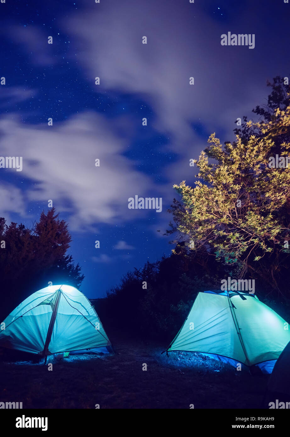 Glowing tent in the mountains under a starry sky Stock Photo - Alamy