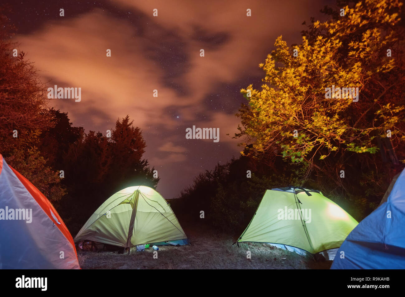 Glowing tent in the mountains under a starry sky Stock Photo - Alamy