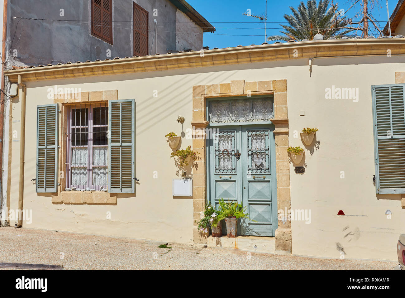 Blue shutters window and door on sidewalk in Cyprus Stock Photo - Alamy