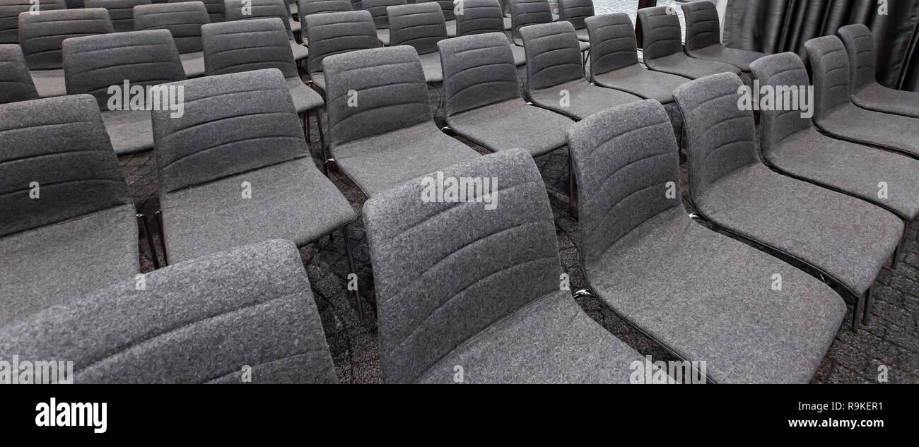 Group of empty gray chairs in modern conference hall - presentation room for seminars Stock Photo