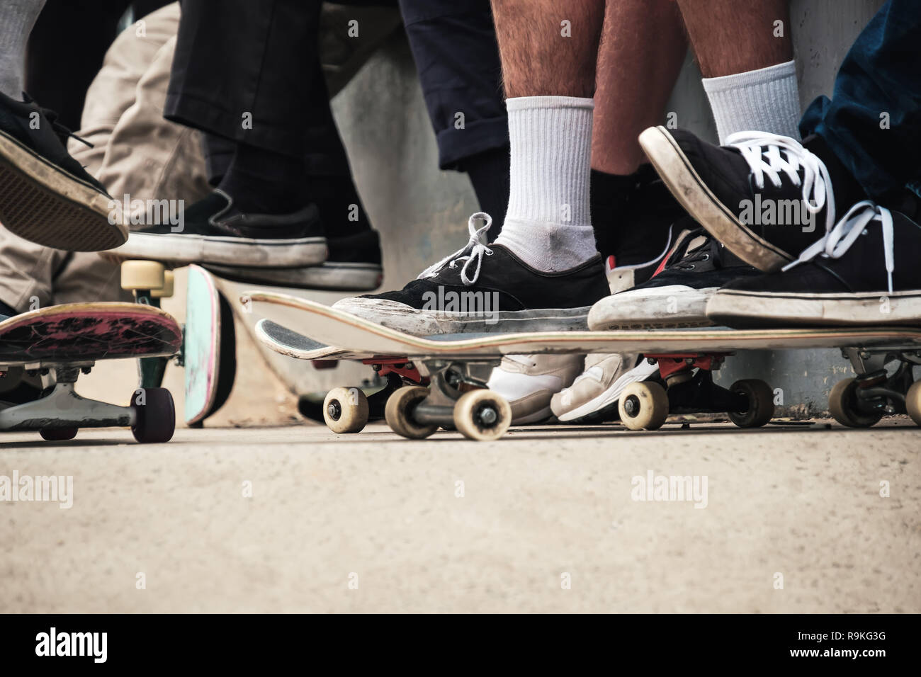 Foot of unknown men on top of skateboards ready to roll Stock Photo