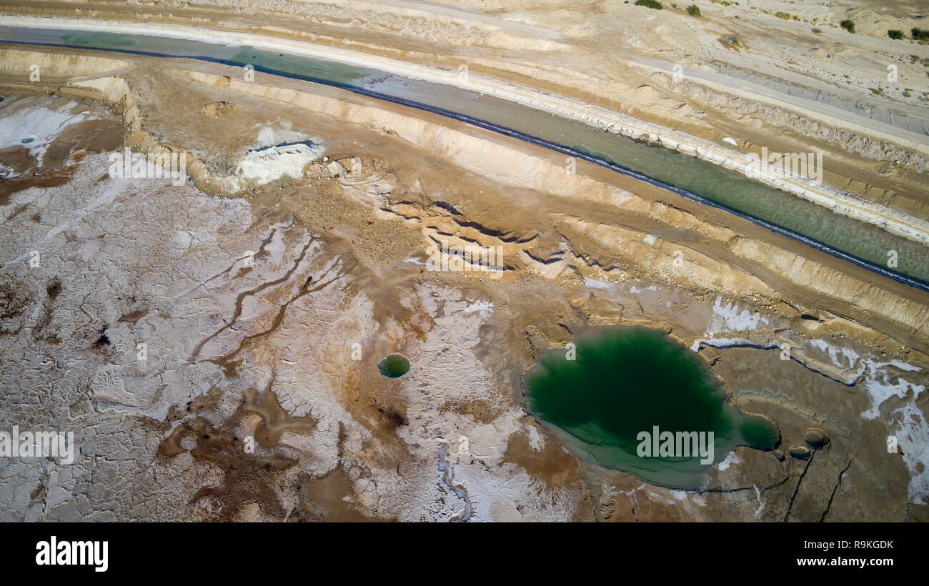 Aerial Photography with a drone. Elevated view of sink holes on the shore of the Dead Sea, Israel. The sink holes are caused by the rapidly receding w Stock Photo