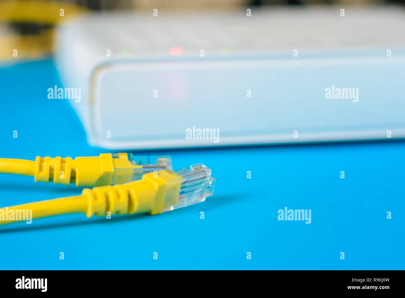 unplugged ethernet cable and internet router on blue background Stock ...