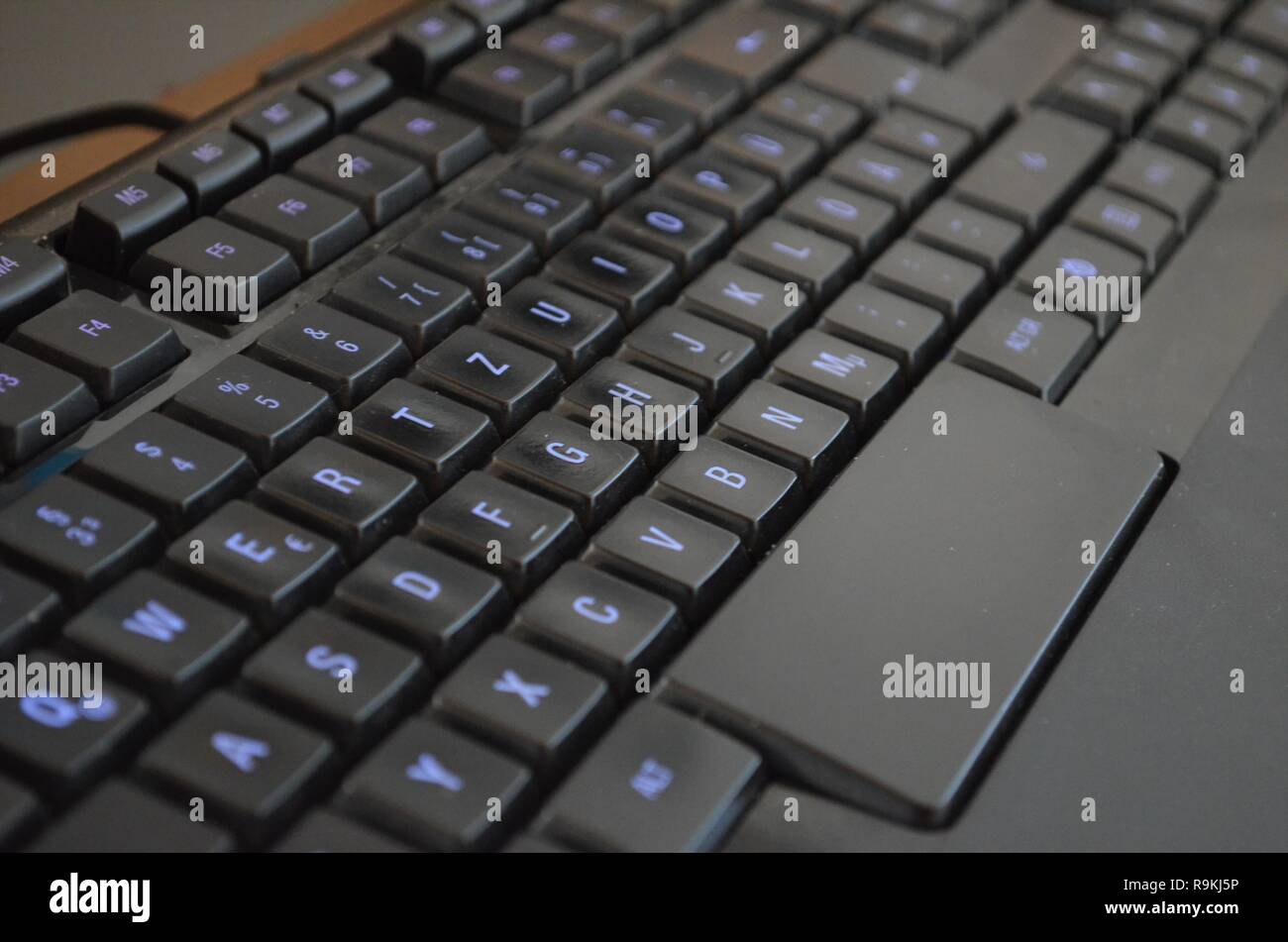 black gaming keyboard with blue glowing keys Stock Photo Alamy