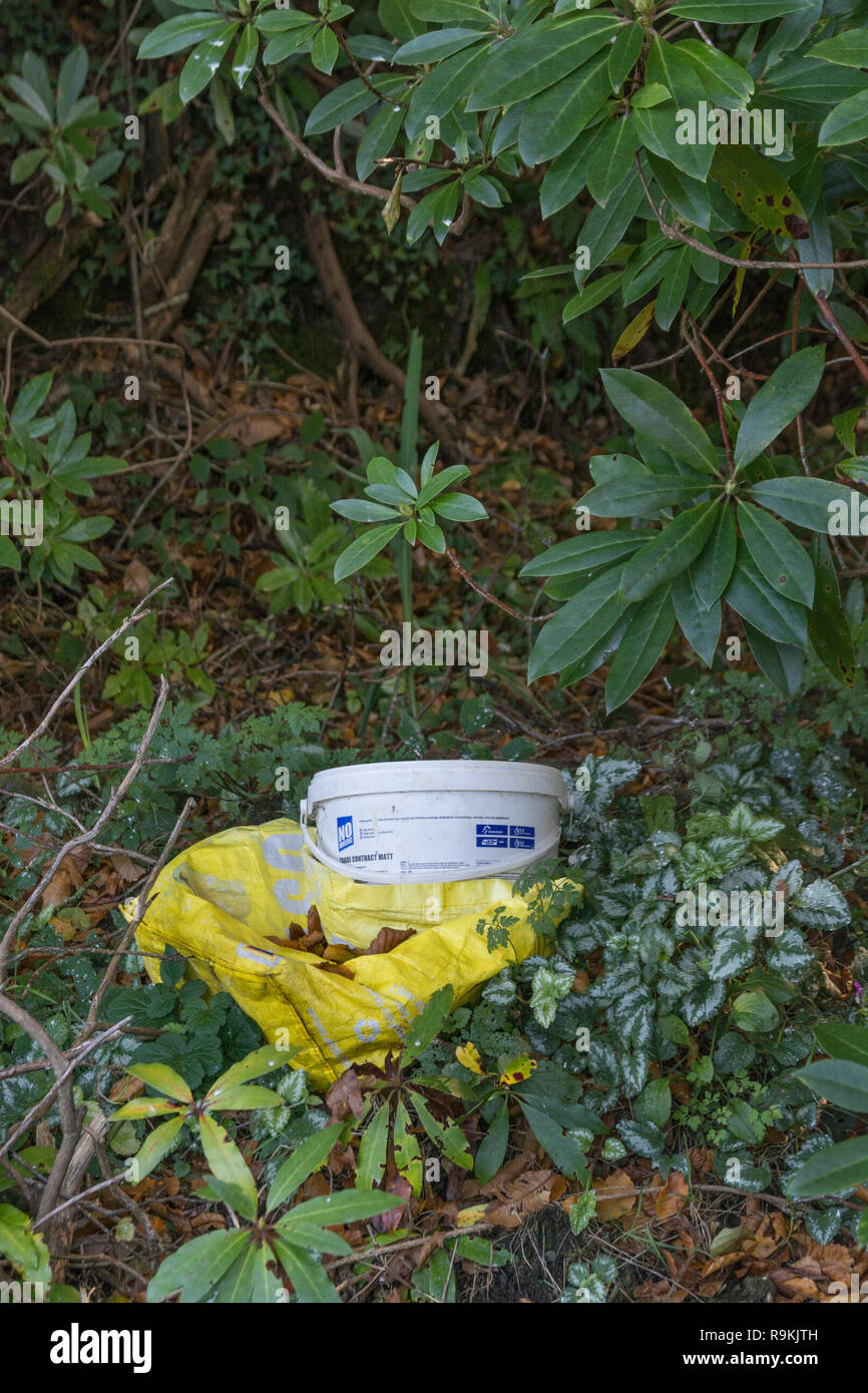 Plastic decorating gear discarded in rural hedgerow. Metaphor on war on plastic, plastic pollution, plastic rubbish, Clean Up Britain campaign. Stock Photo