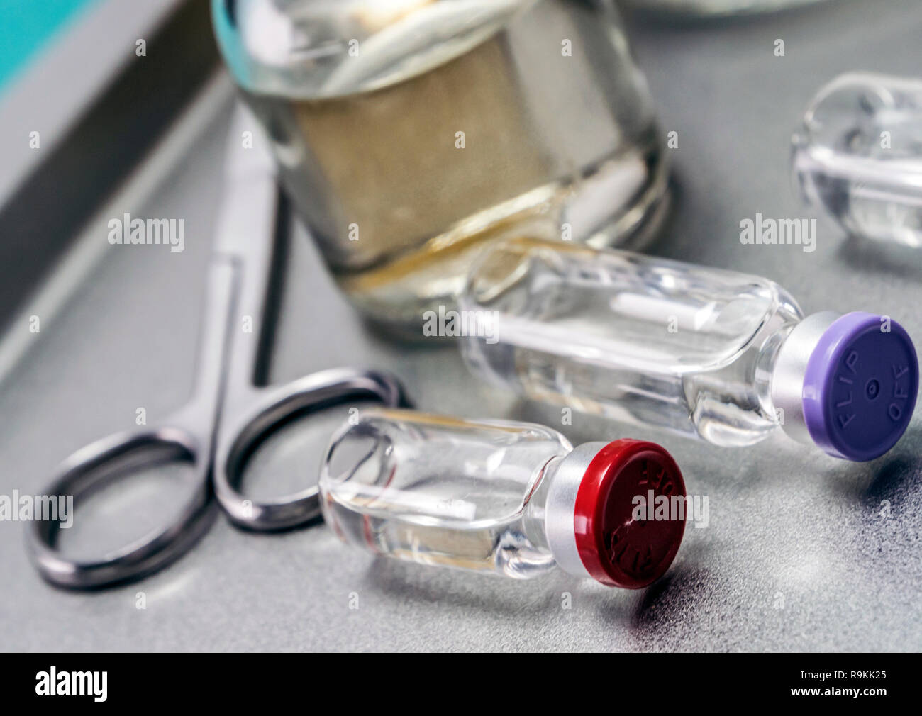 Some vials next to a syringe Stock Photo
