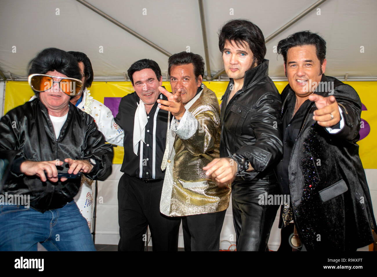 Five costumed Elvis Presley impersonators line up on the stage of a music festival in Fullerton, CA. Stock Photo