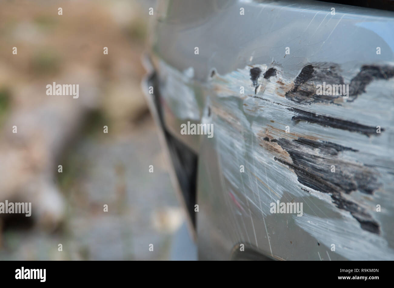 Damaged car bumper after crashing into a guard rail whilst spinning out of control Stock Photo