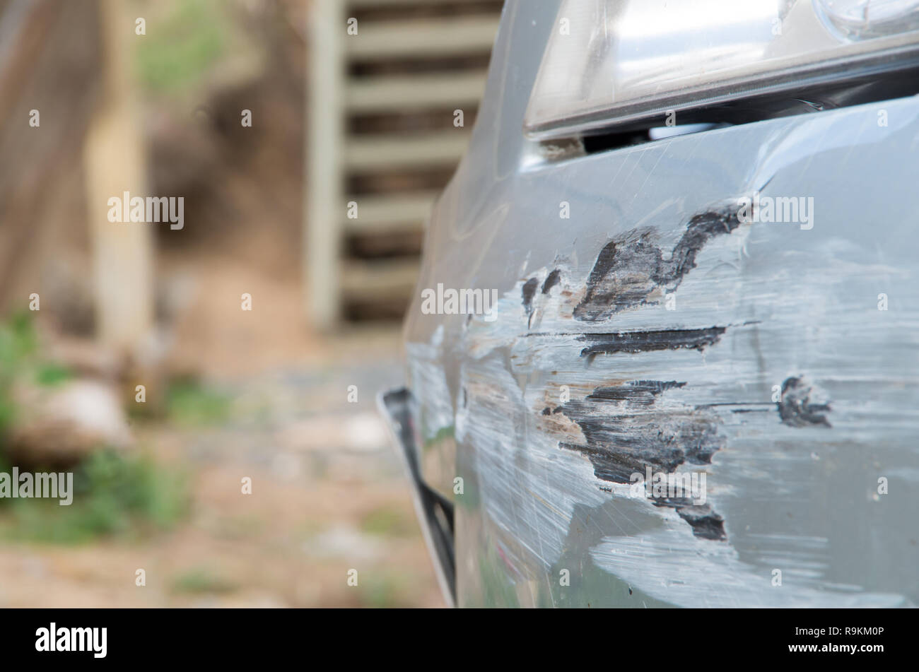 Damaged car bumper after crashing into a guard rail whilst spinning out of control Stock Photo