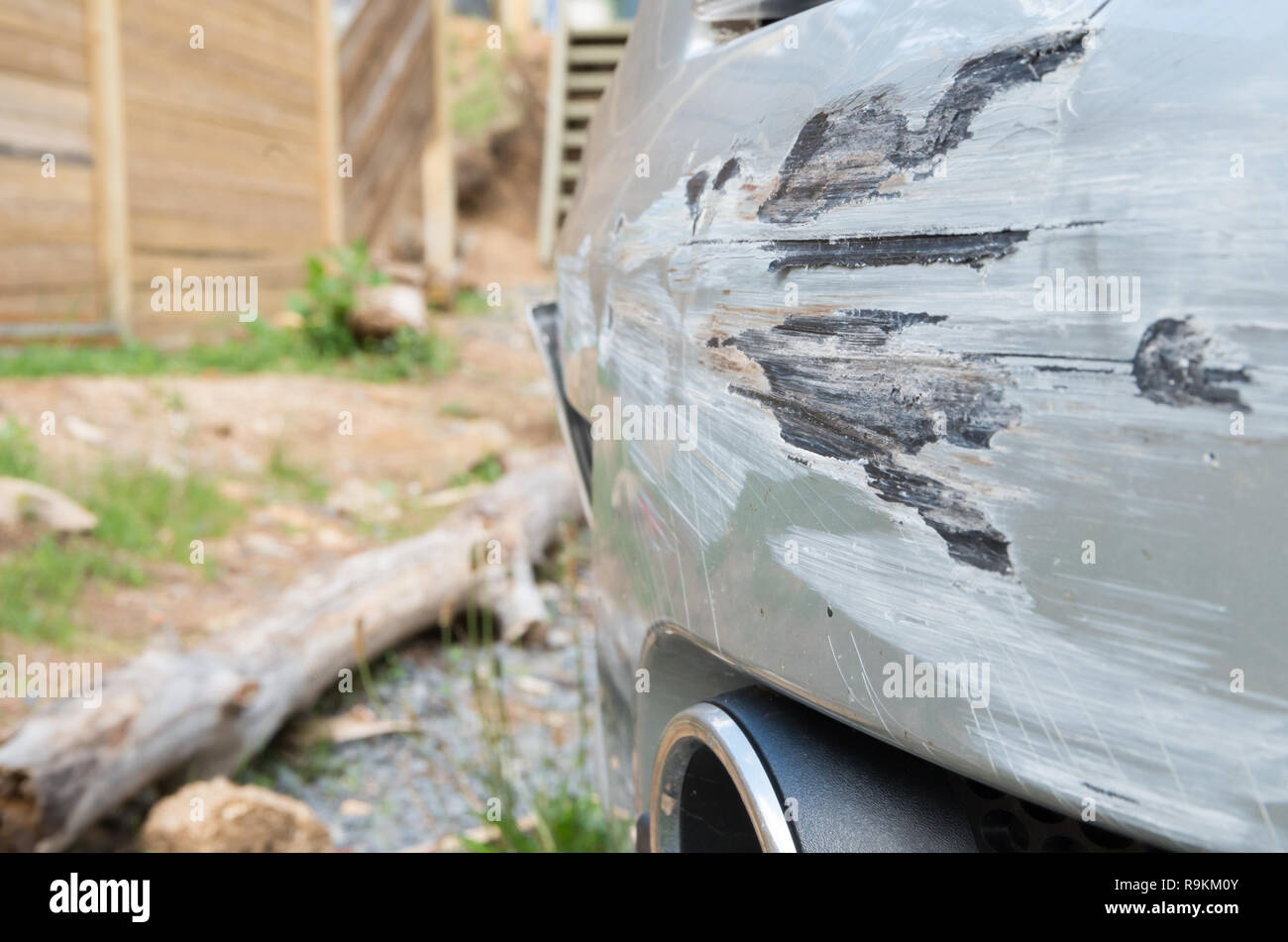 Damaged car bumper after crashing into a guard rail whilst spinning out of control Stock Photo