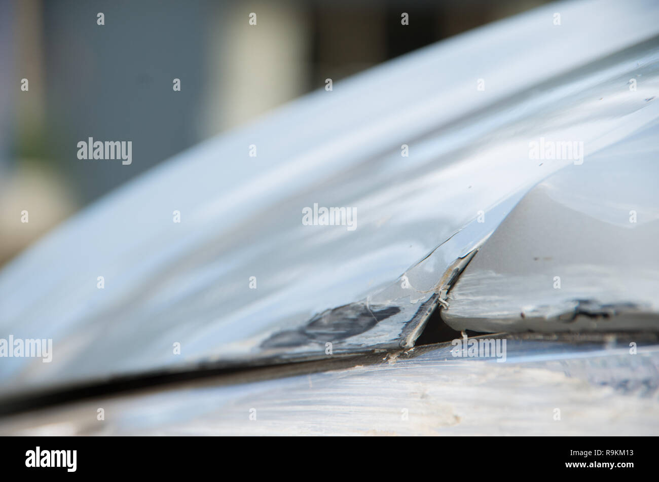 Bent car bonnet (hood) after colliding with a guard rail whilst spinning out of control Stock Photo