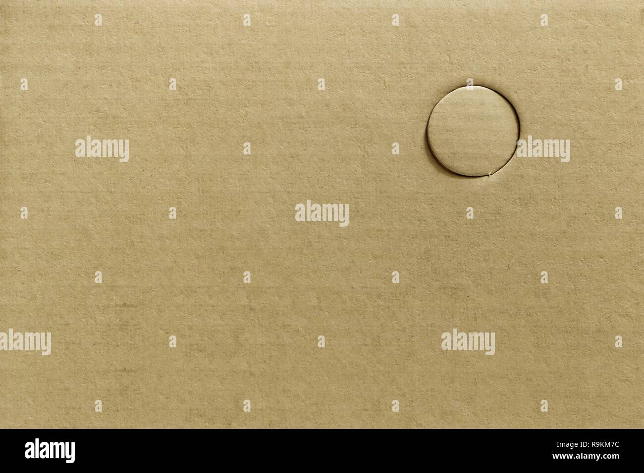 Texture of cutting hole brown paper or drilling holes on cardboard